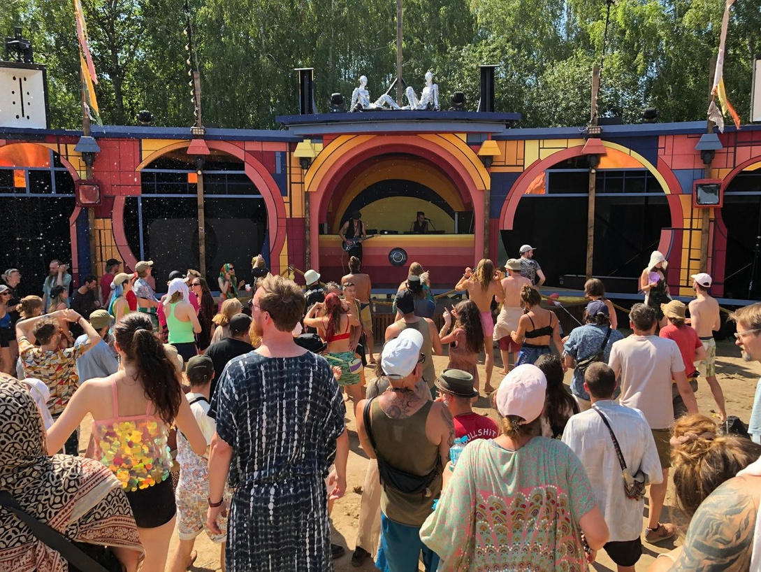 Extravaganza stage and festival crowd in daylight